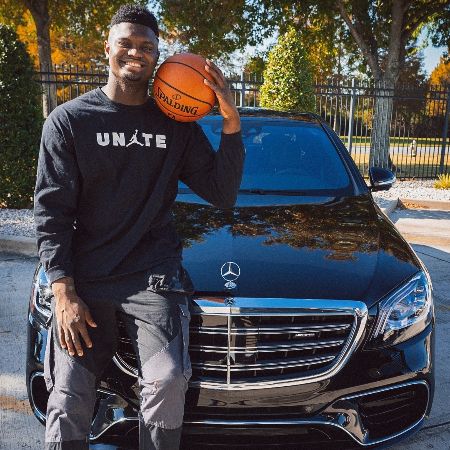 Zion Williamson is posing for a photo with his car.